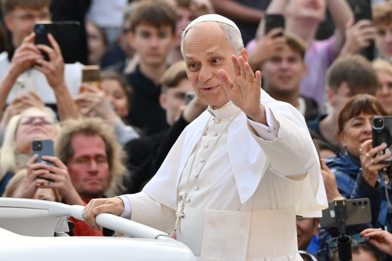 Pope Leo XIV responds to a Cubs fan during a parade in Vatican City